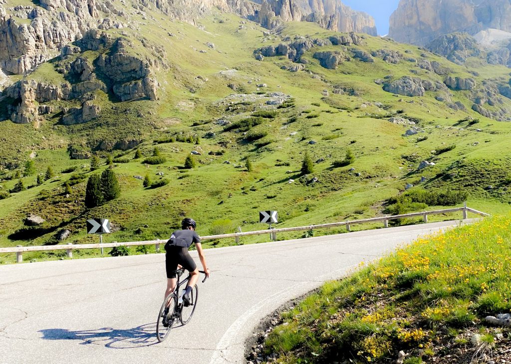 Cyclist climbing Passo Sella